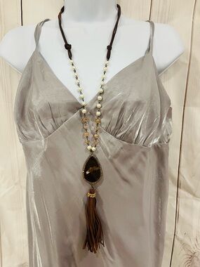 22in Necklace ,Animal Print Pendant with leather strand and tassel, faux pearls.